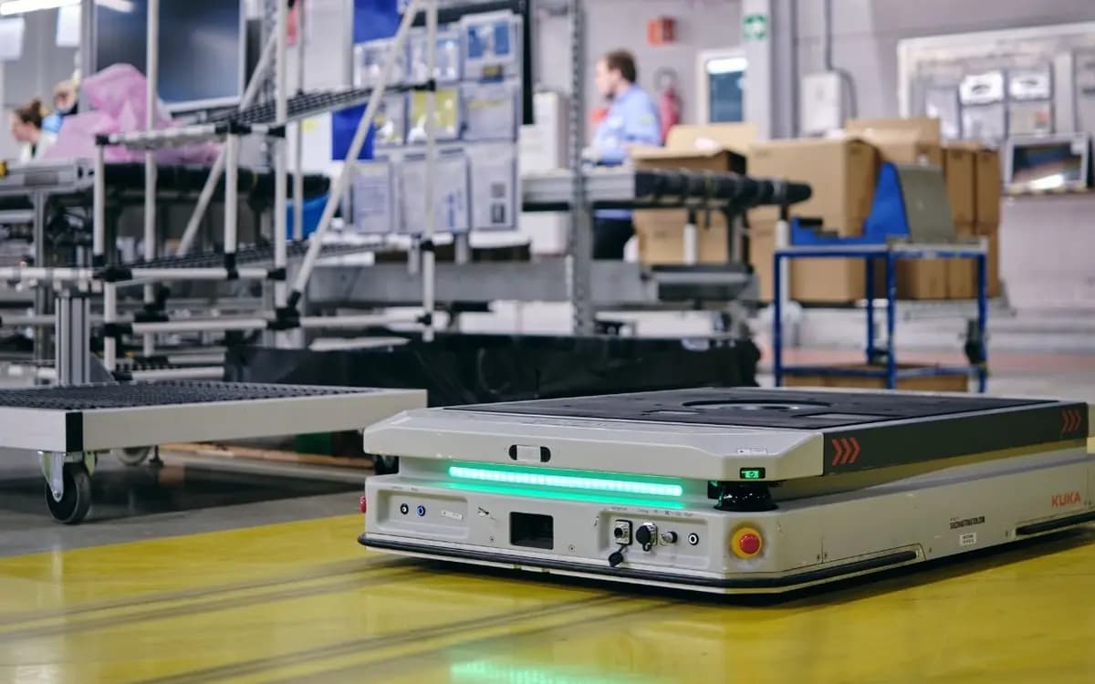 A KUKA mobile platform beside a production line