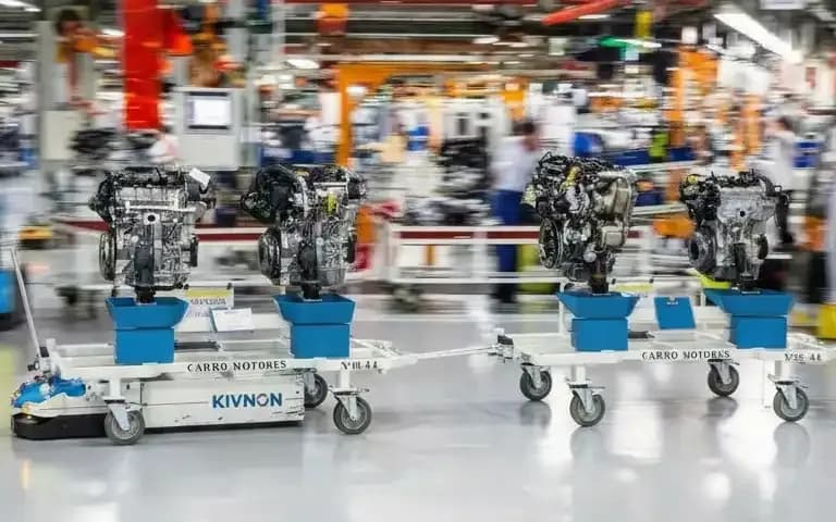 A Kivnon AGV towing a train of carts loaded with engines